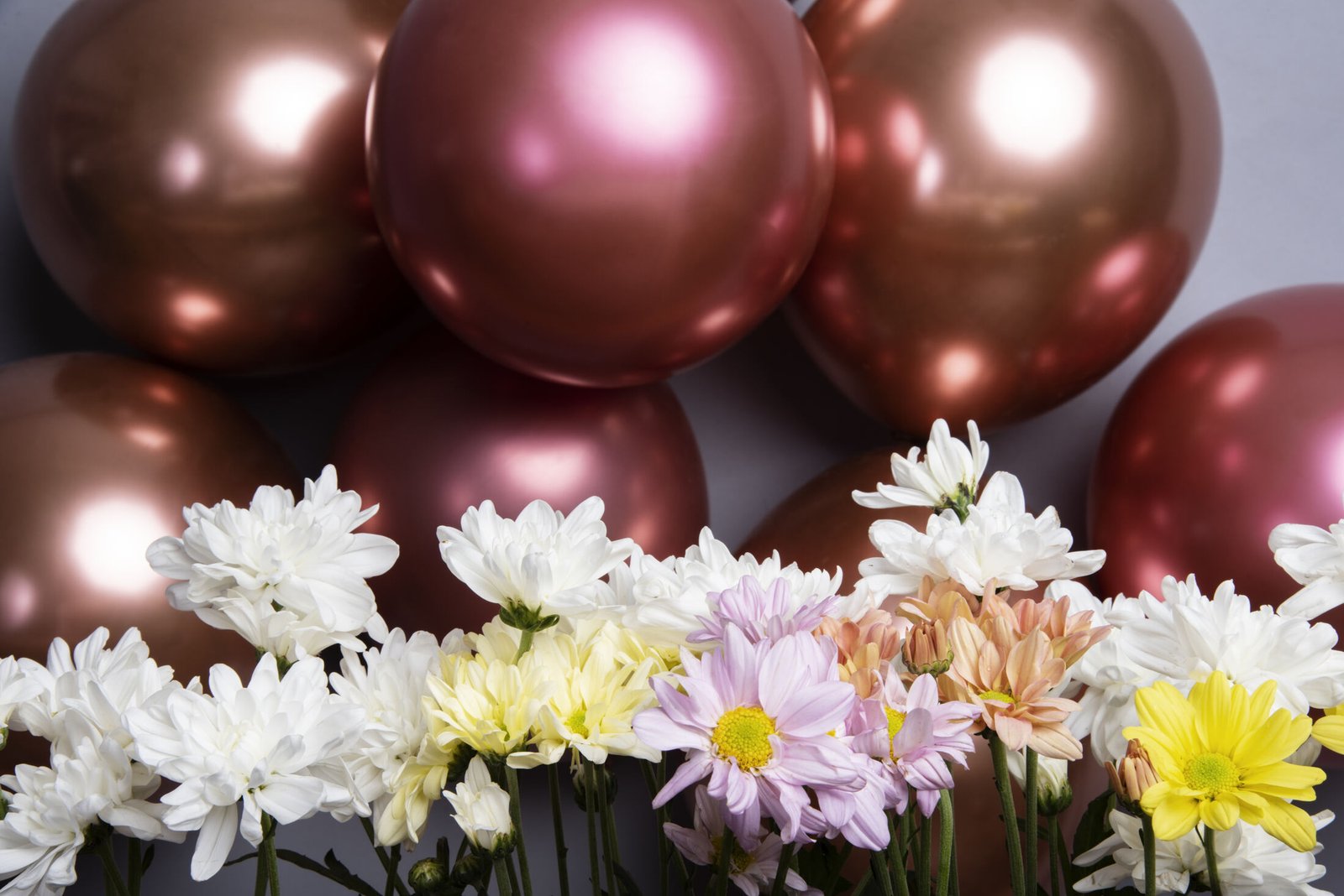 Luxury metallic balloon and fresh flower styling for a birthday celebration