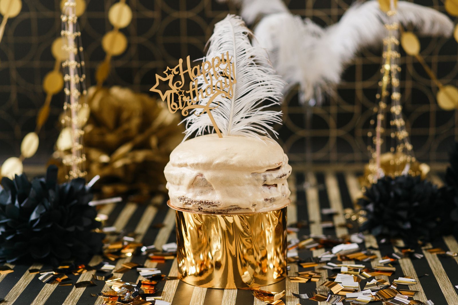 Luxury birthday cake table styled with gold and black party decor